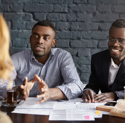 charismatic dark skinned recruiter gesturing actively while trying convince unrecognizable female